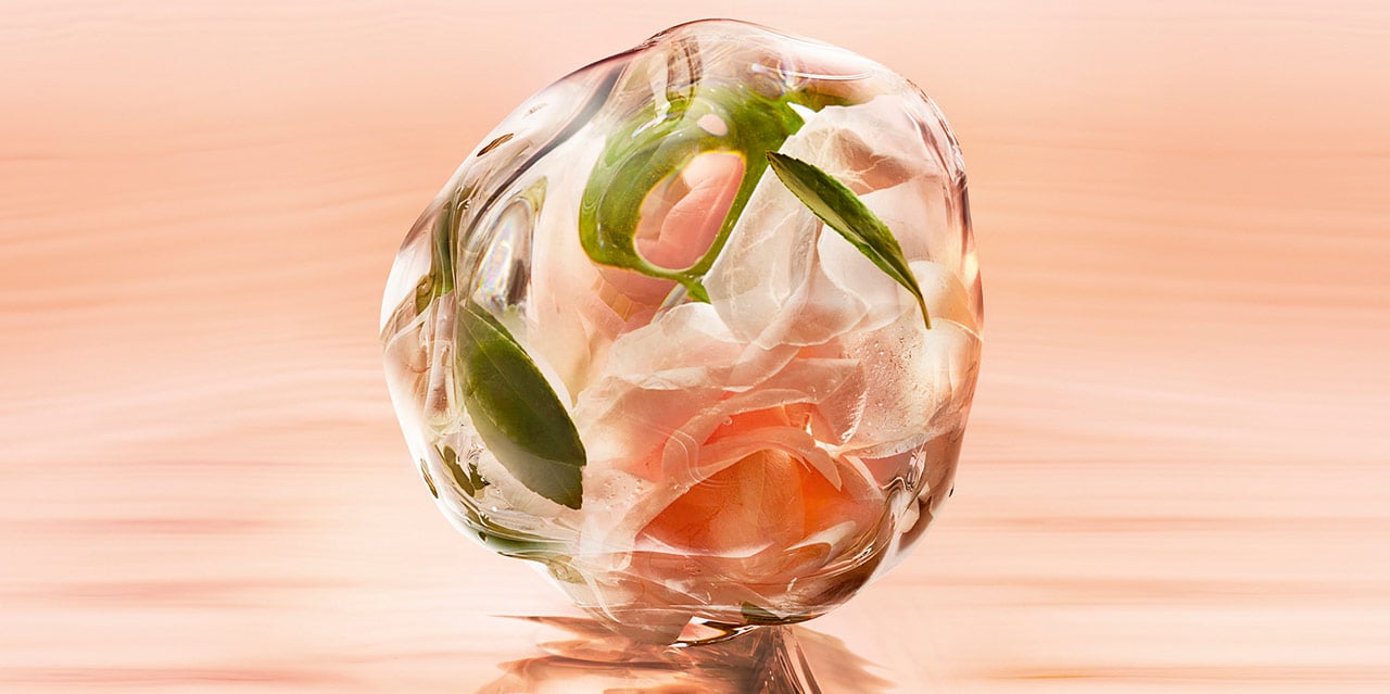 Green tea rose perfume droplet with ingredients shown inside to represent the notes of Idole eau de toilette